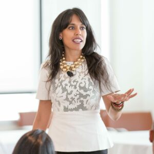 Close up of Ritu Bhasin in 2014 presenting a keynote speech on a conference room